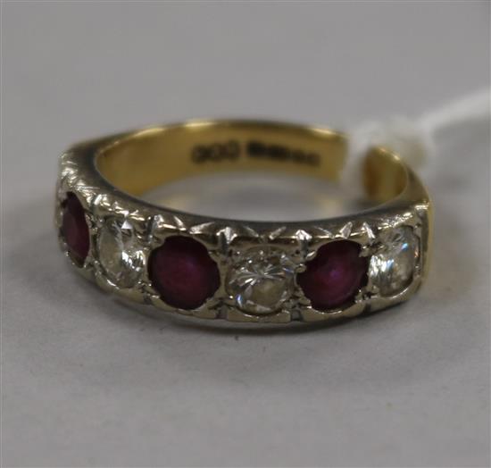 A modern 18ct gold, ruby and diamond seven stone half hoop ring, size Q.